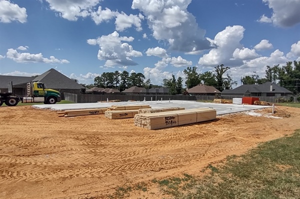 How do homeowners know if their land is suitable for building a home?